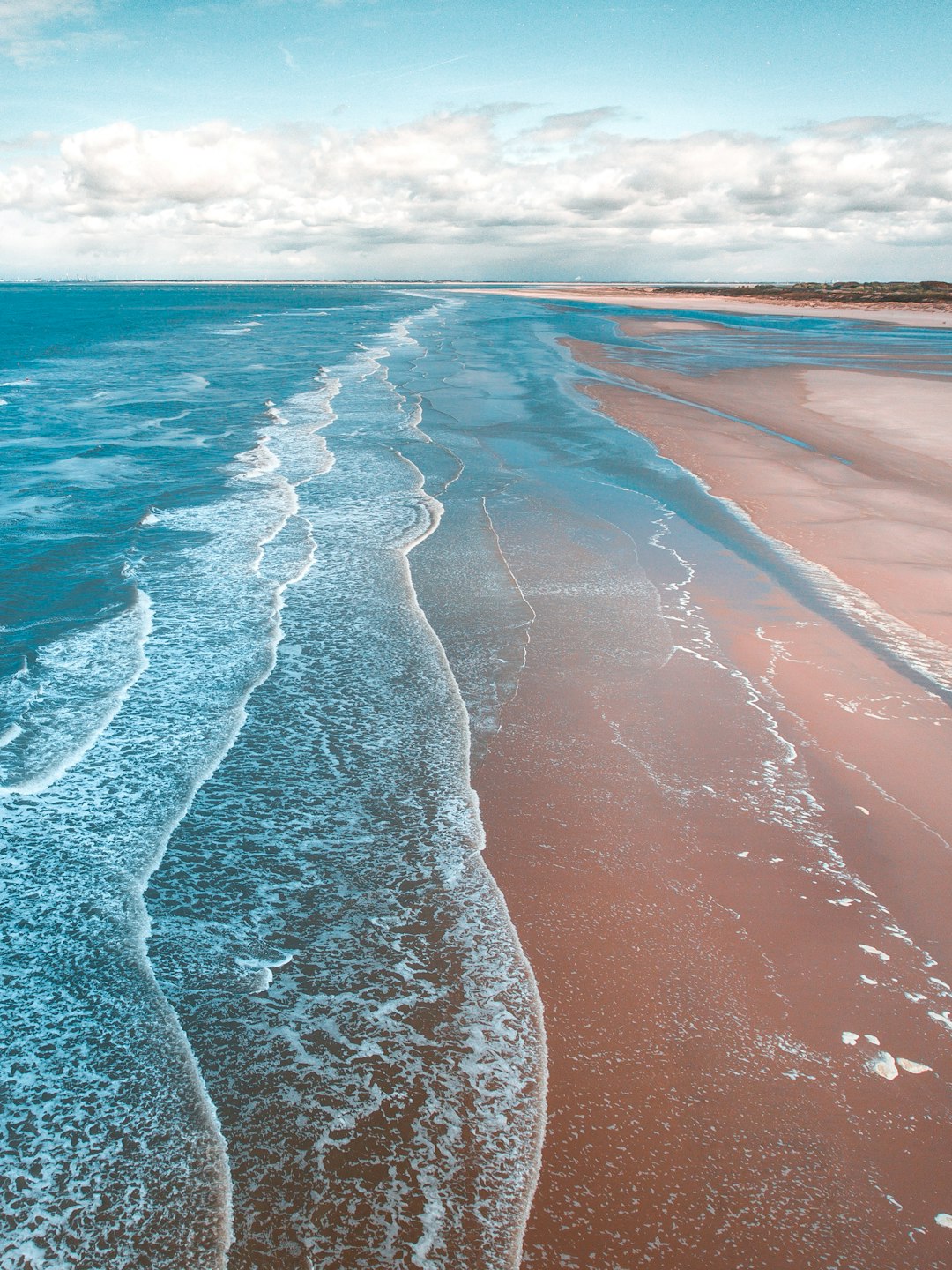 Aerial view of a stunning Brazilian beach with turquoise waters and lush greenery